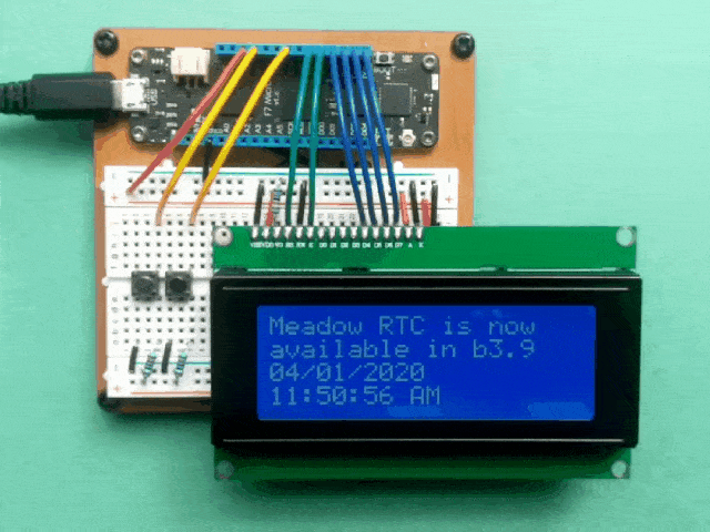 Video showing a Meadow connected to a multi-line character display showing text, Meadow RTC is now available in b3.9, followed by the date and then the current time with the seconds incrementing.