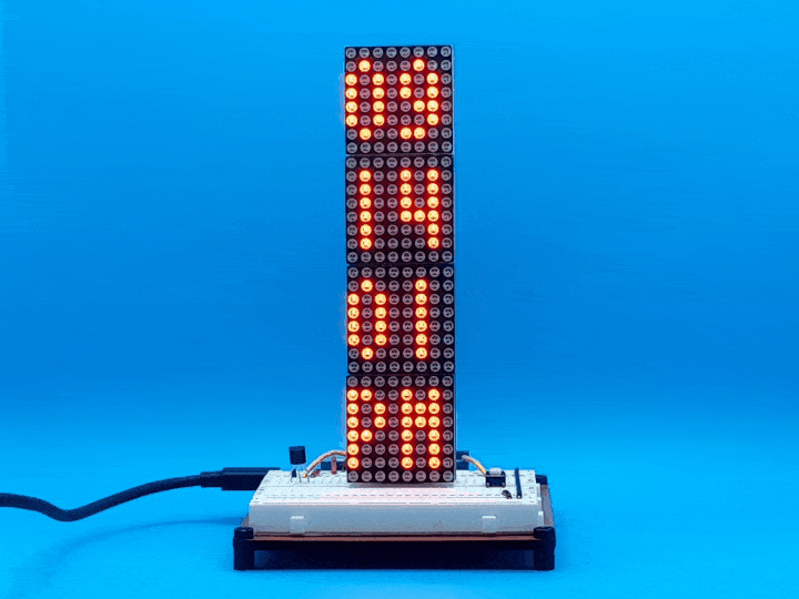 Video showing a vertical LED matrix showing the current date and then the current time when a button is pressed.