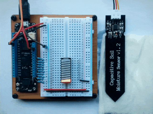 Video of a Meadow board connected to a moisture sensor and displaying a rising LED bar graph fill as a wet paper towel is applied to the sensor.
