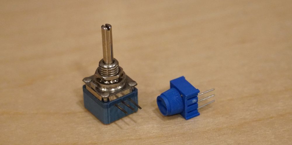 Photo of a pair of potentiometers, each with three leg pins, but one has a metal post for attaching a knob and the other has a small integrated knob.