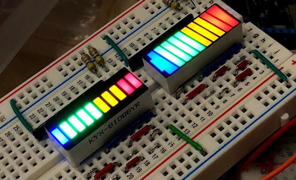 Photo of two components each made from several different-colored LEDs. One component is simply several LEDs next to each other. The other has the LEDs grouped to look like a battery where the number of LEDs illuminated indicates the level of charge in the battery.