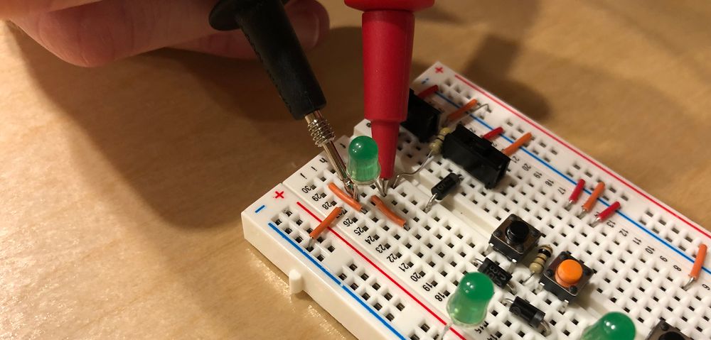 Image of multimeter test leads on both sides of the LED.