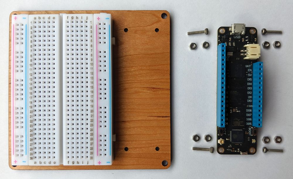 Protoboard with breadboard mounted and Meadow adjacent with mounting hardware.