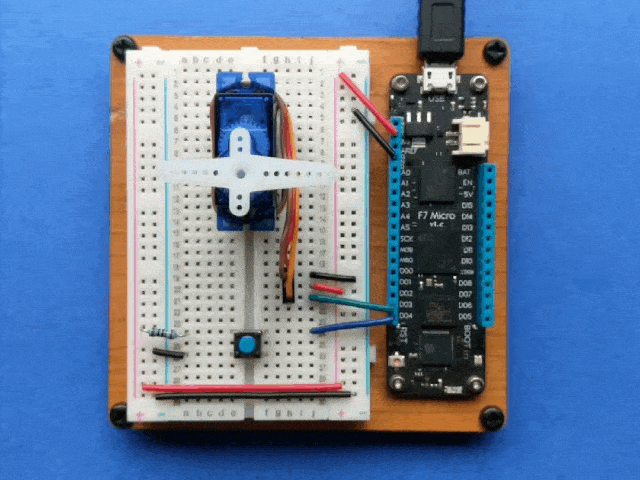 Video of a Meadow board connected to a button and servo, where pressing the button rotates the servo counter-clockwise approximately 90 degrees.