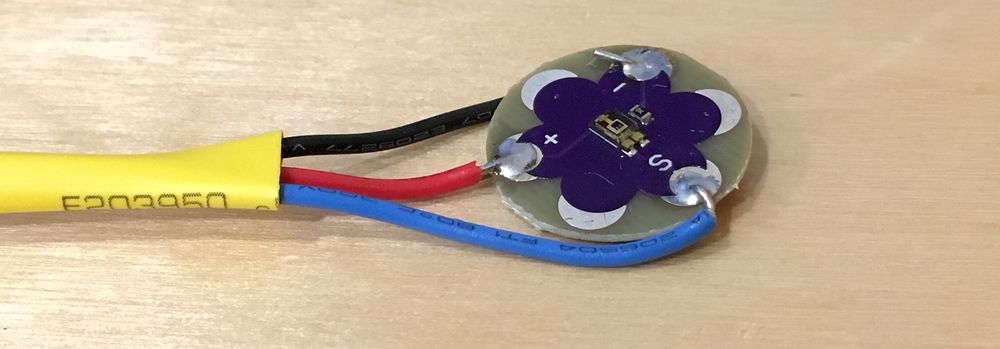 Photo of the finished LilyPad Sensor with wires soldered to it.