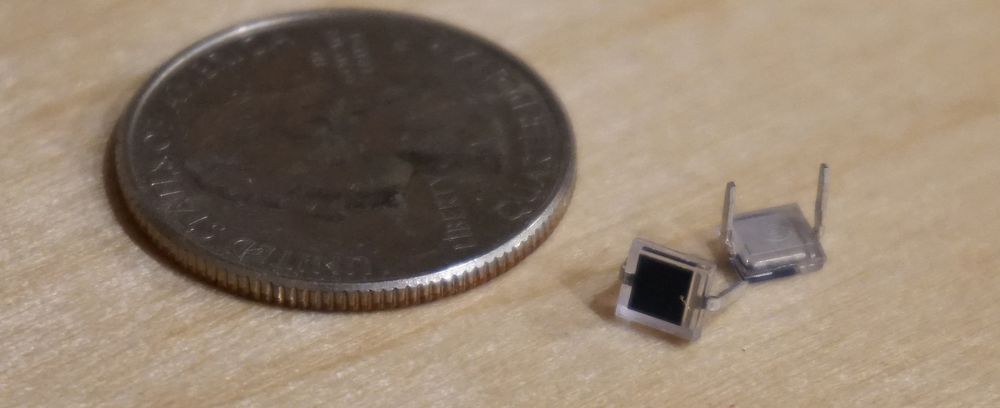 Image of a photodiode next to a United States quarter coin for scale. About 20 diodes would fit on top of the coin.